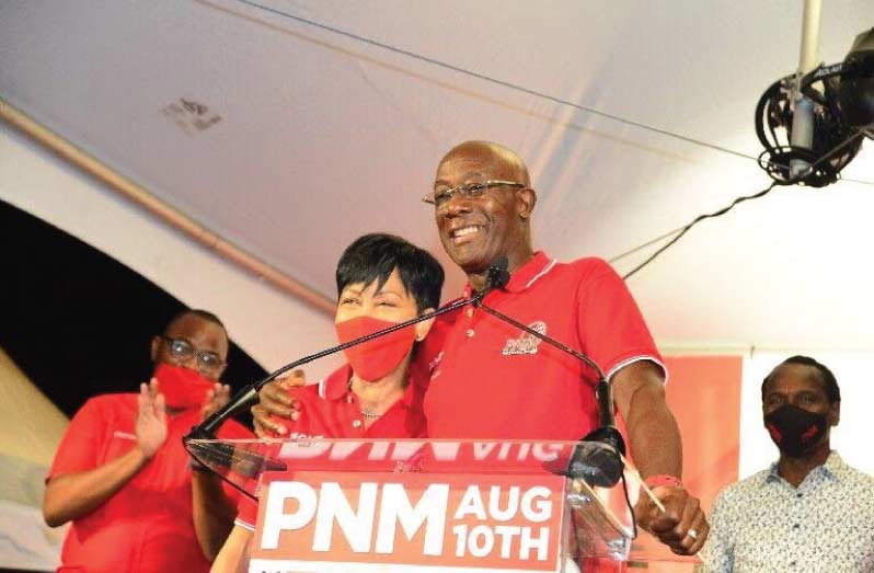 WINNING SMILE: Prime Minister Dr Keith Rowley smiles as he hugs his wife, Sharon Rowley, during his victory speech following the results in the 2020 general election last night at PNM headquarters at Balisier House in Port of Spain. Photo: ISHMAEL SALANDY