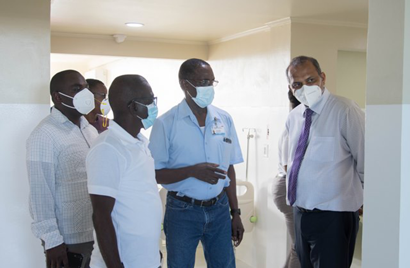 Minister of Health, Dr. Frank Anthony being given a guided tour of the COVID-19 hospital by Director of Medical and Professional Services, Dr. Fawcett Jeffrey and CEO of the GPHC, Brigadier Retired George Lewis. Also, in the photo is Minister of Public Affairs within the Office of the Prime Minister, Kwame McCoy along with other from the GPHC.