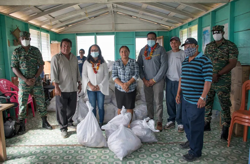 Minister of Amerindian Affairs, Pauline Sukhai, Minister of Local Government and Regional Development, Nigel Dharamlall, Director-General of the Civil Defense Commission (CDC), Lieutenant-Colonel, Kester Craig, and Major Loring Benons handing over the supplies to residents of Paramakatoi recently