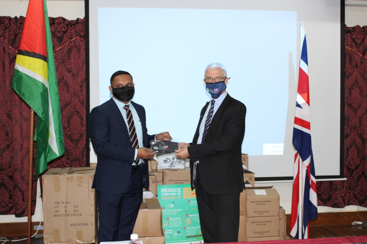 Minister of Natural Resources, Vickram Bharrat (left) receives the contribution from H.E Ray Davidson
