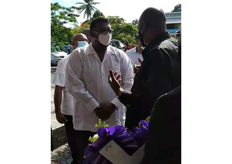Leader of the Opposition, Joseph Harmon speaks with President Irfaan Ali outside the funeral parlor on Sunday