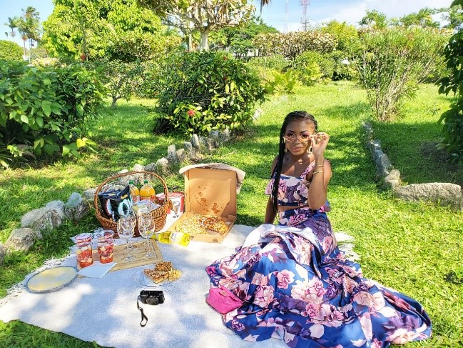 Andrea Bernard showcasing fashion suited for a picnic in Promenade Gardens.