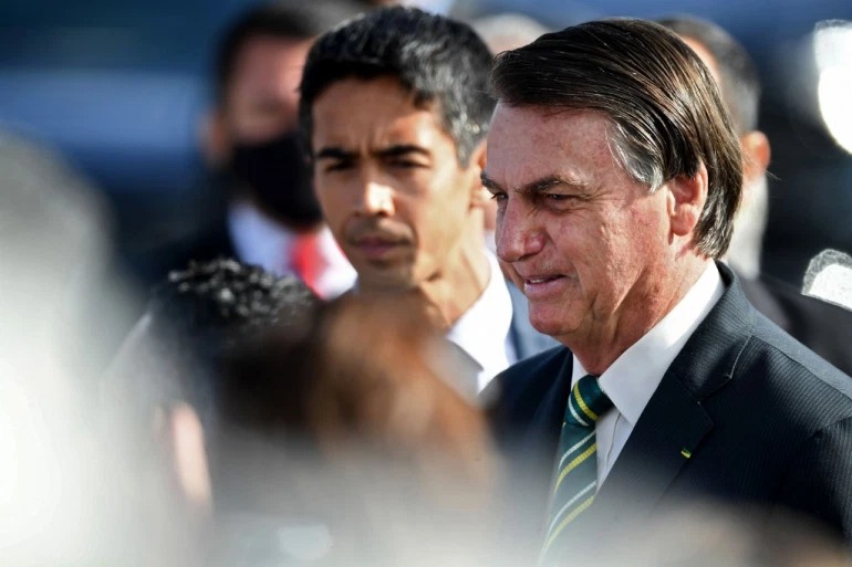 Bolsonaro has followed US President Donald Trump's policy on coronavirus closely, expressing resistance against lockdowns citing its impact on the economy [Evaristo Sa/AFP]