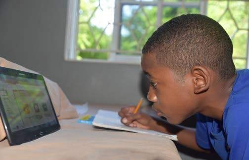 Calabar High School first-form student Mathoni Brooks, concentrates during a virtual class via Google Classroom recently. (Photo: Jason Tulloch)