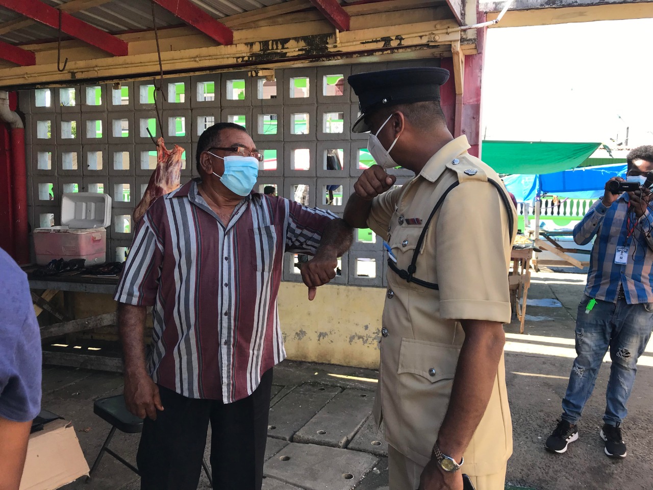 Commander Regional Division No. 6 Superintendent Jairam Ramlakhan greets a resident at the Port Mourant Market