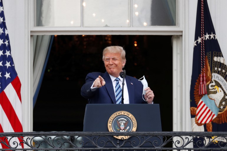 U.S. President Donald Trump addressed supporters from a White House balcony on Saturday, his first public appearance since he tested positive for COVID-19 on October 1. [Tom Brenner/Reuters]