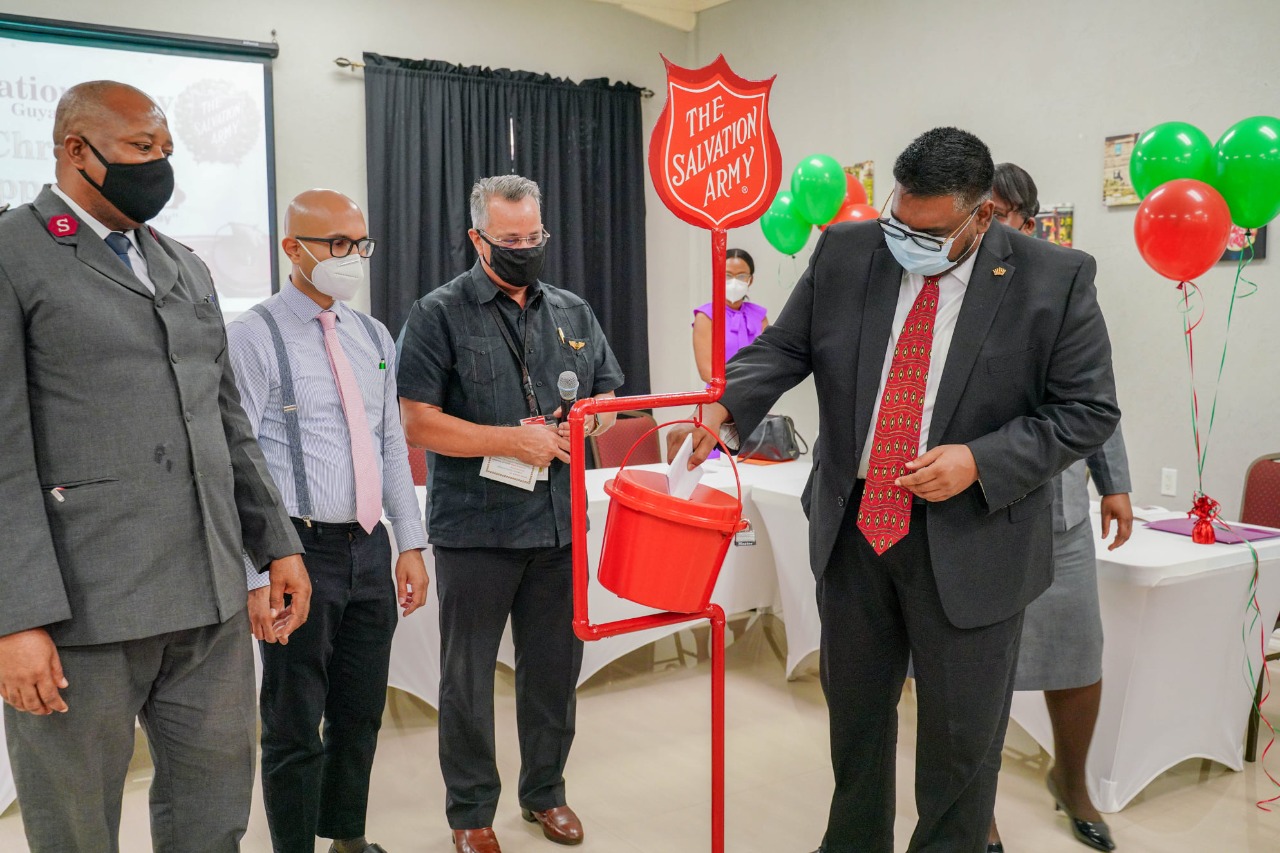 President Irfaan Ali makes the first deposit into the Salvation Army's annual Christmas Kettle Appeal