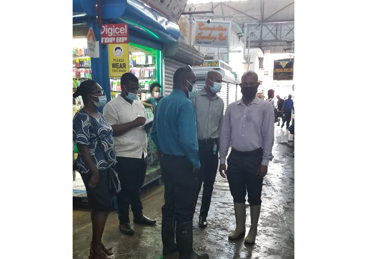 Local Government Team on the ground meeting with vendors in the flooded market
