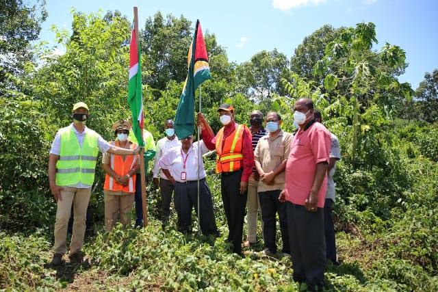 Minister of Public Works, Hon. Bishop Juan Edghill along with the Surinamese and Guyanese delegation trekking through the bushes to plant the flags at the location for the bridge on the Guyana border