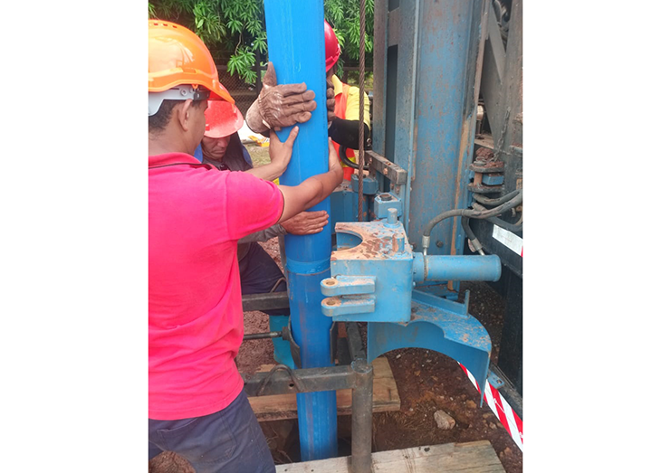 Technicians install a casing on the well (GWI)