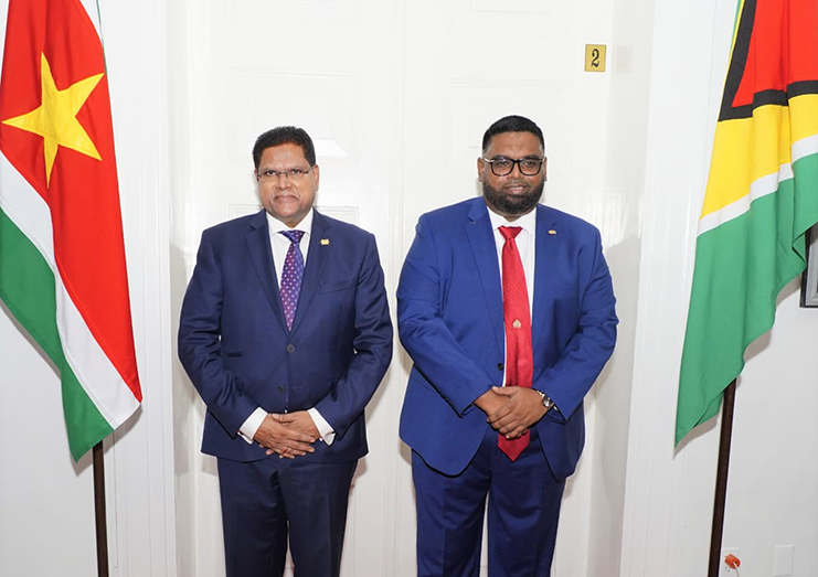 : President Irfaan Ali (right) with Suriname's President Chandrikapersad Santokhi (OP photo)