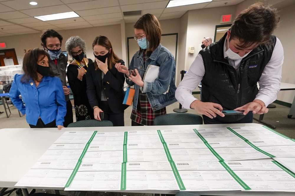 Democratic and Republican canvas observers inspect Lehigh County provisional ballots as vote counting in the general election continues, Friday, Nov. 6, 2020, in Allentown, Pa. (AP Photo/Mary Altaffer)