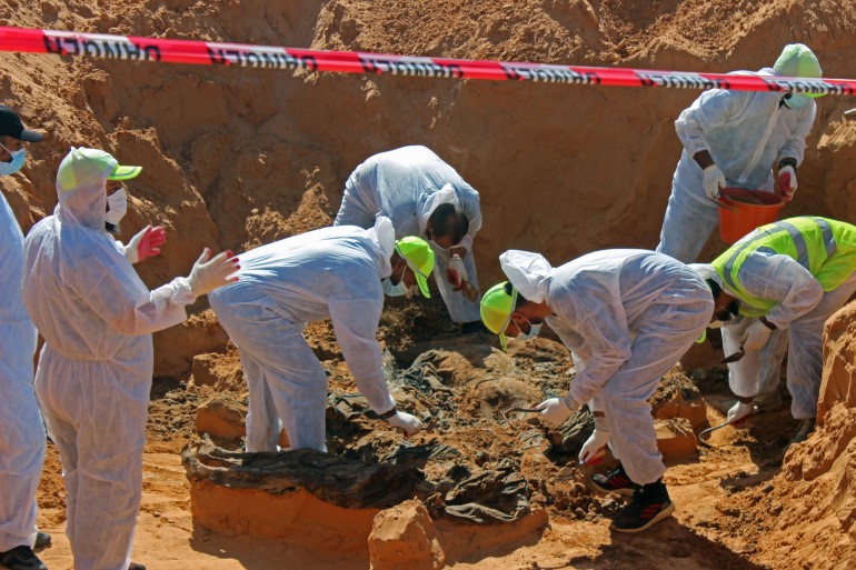 Officials exhume bodies in what Libya's internationally recognised government officials say is a mass grave in Tarhuna city, Libya [File: Ayman al-Sahili/ Reuters]