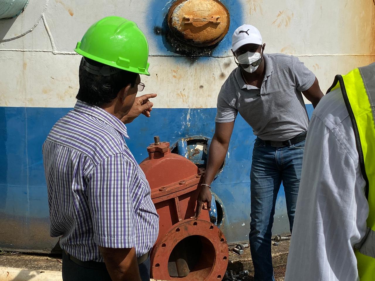 GWI's Chief Executive Officer Shaik Baksh gestures to a technician at the Eccles Water Treatment Plant (GWI)