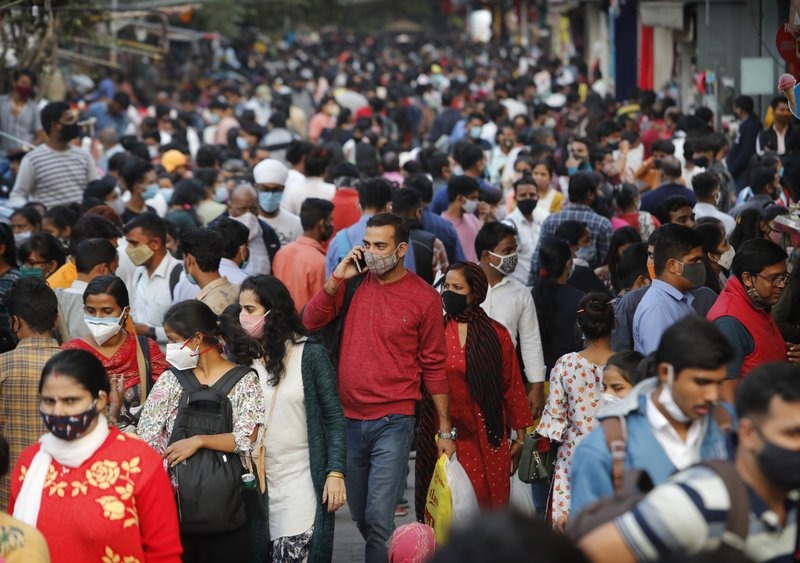 People throng a market to shop ahead of the Diwalli festival in New Delhi, India, Thursday, Nov. 12, 2020. Authorities in New Delhi have banned firecrackers and are appealing to people to celebrate the Hindu festival of lights at home. Coronavirus infections have been rising in the capital and authorities are worried large festival crowds will worsen the virus situation.(AP Photo/Manish Swarup)