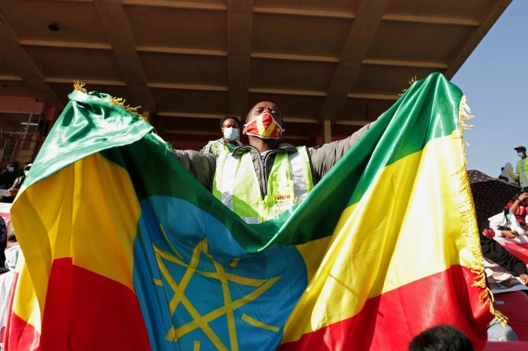 A volunteer holds an Ethiopian flag during a blood donation drive for the injured members of Ethiopia's military fighting against Tigray's special forces [Tiksa Negeri/Reuters]