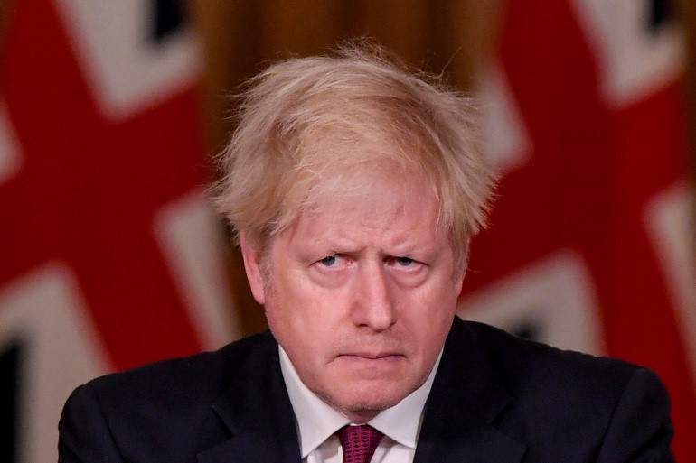 UK PM Boris Johnson is under immense pressure as his country battles a new coronavirus strain days before leaving the EU single market [File: Toby Melville/Reuters]