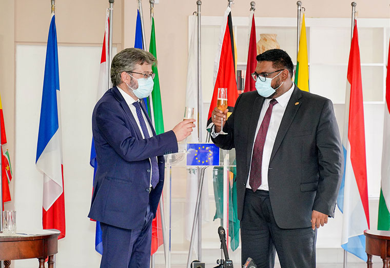 President Irfaan Ali and Ambassador of the EU Delegation to Guyana, Fernando Ponz Cantó toasting to the toasting to the $19.8B grant under the EU Budget Support Programme