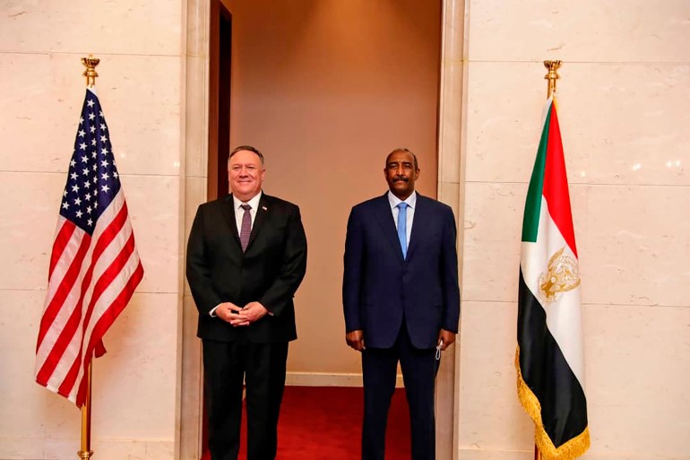 US Secretary of State Mike Pompeo, left, with Abdel-Fattah Burhan, head of Sudan's ruling sovereign council, in Khartoum in this August 25, 2020 photo [Sudanese Cabinet via AP]