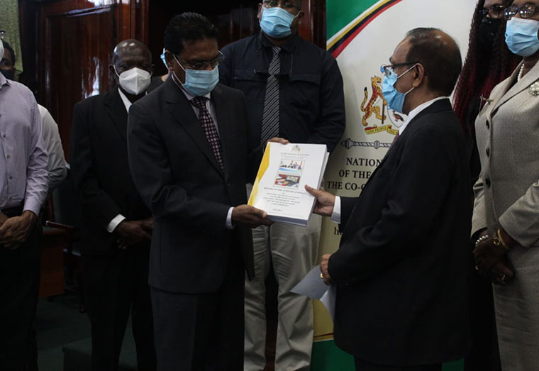 Speaker of the National Assembly, Manzoor Nadir (left) accepts the Auditor General's Report for Fiscal Year Ended December 31, 2019 from Auditor General, Deodat Sharma
