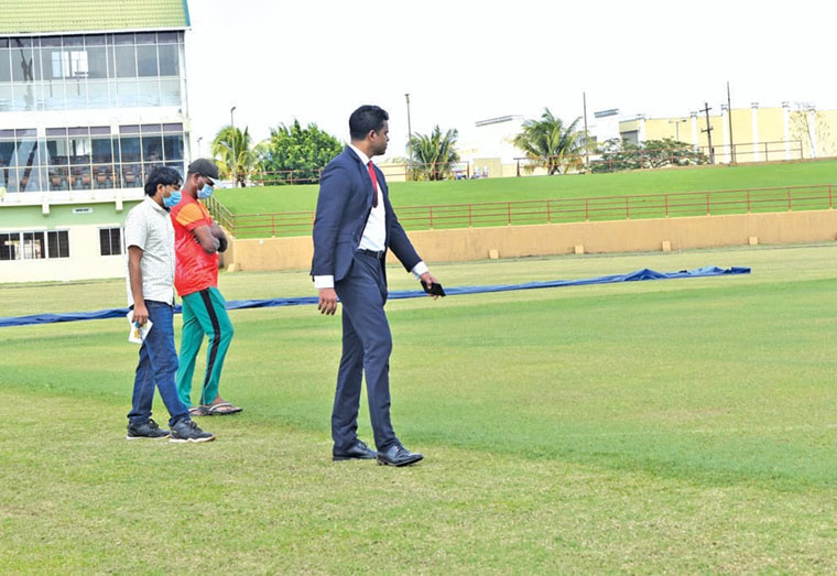 Minister of Sports, Charles Ramsom inspects the outfield at the Guyana National Stadium, Providence