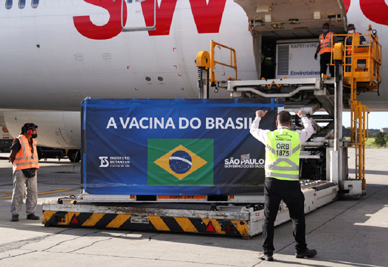 A refrigerated container with China's Sinovac COVID-19 vaccines arrives at Sao Paulo International Airport in Guarulhos, Brazil December 30, 2020 [Amanda Perobelli/Reuters]