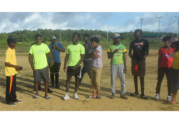 Black (at extreme left) interacting with members of the YAYSC in a recent field training session in West Coast Berbice.