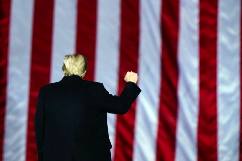 President Donald Trump gestures at a campaign rally in support of U.S. Senate candidates Sen. Kelly Loeffler, R-Ga., and David Perdue in Dalton, Ga., Monday, Jan. 4, 2021. (AP Photo/Brynn Anderson)