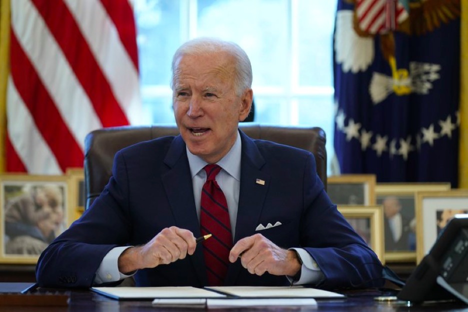 President Joe Biden signs a series of executive orders on health care, in the Oval Office of the White House, Thursday, Jan. 28, 2021, in Washington. The Democratic push to raise the minimum wage to $15 an hour has emerged as an early flash point in the push for a $1.9 trillion COVID relief package, providing an early test of President Joe Biden's ability to bridge Washington's partisan divide in pursuing his first major legislative victory. (AP Photo/Evan Vucci)