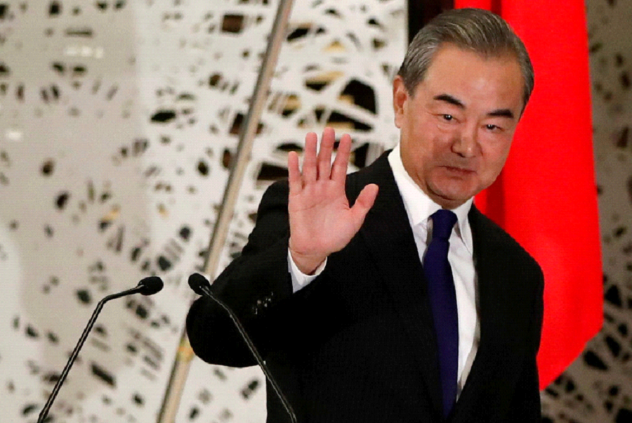 China's State Councillor and Foreign Minister Wang Yi waves as he leaves a news conference in Tokyo [File: Issei Kato/Reuters]