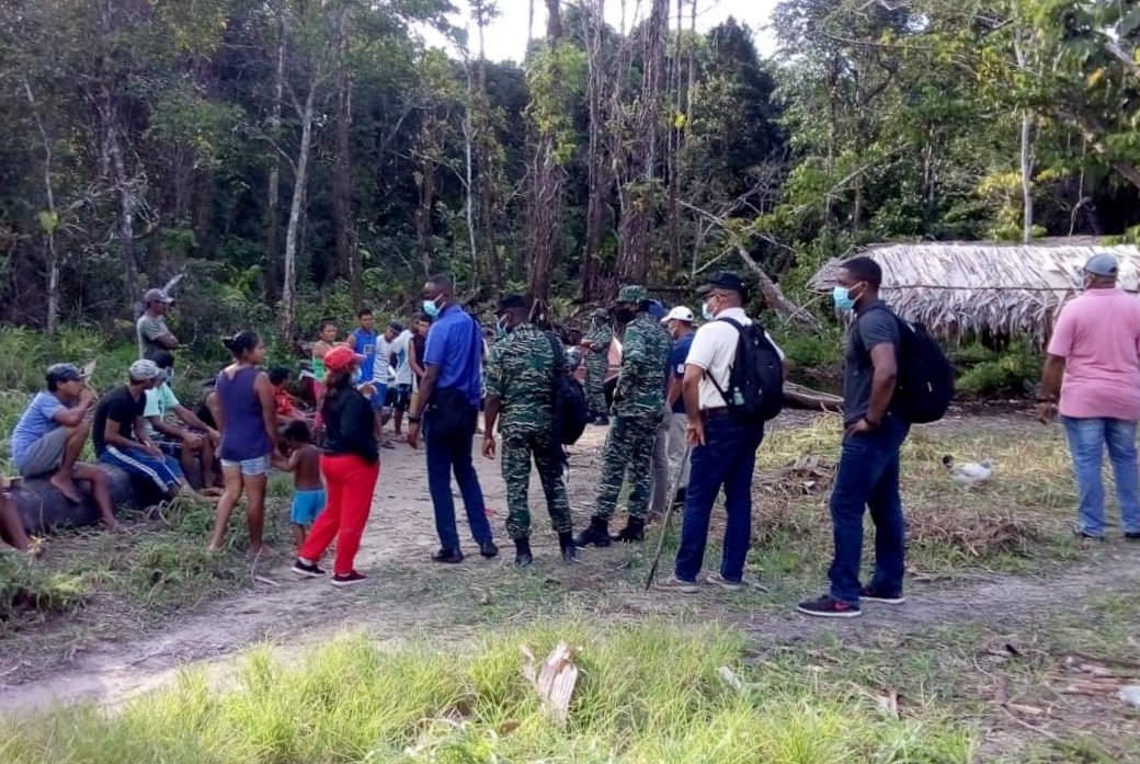 White Water Landing (GDF ranks and other security officials interact with a group of Venezuelan and Guyanese nationals during a visit to Gaja Landing, an area within the village of White Water ,a remote village in the Mabaruma sub-region near the Guyana/Venezuela border)