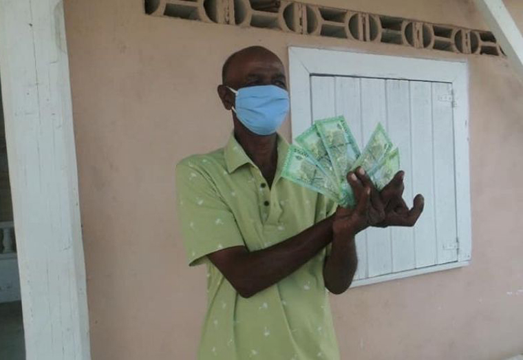 A resident receives the COVID-19 cash grant (Ministry of Human Services and Social Security photo)
