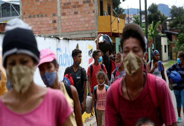 Venezuelan migrants walk towards the border between Venezuela and Colombia, in San Cristobal, Venezuela on October 12, 2020 [Carlos Eduardo Ramirez/Reuters]