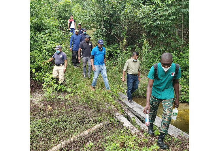 The visiting team along with community members traverse the Kaikan terrain