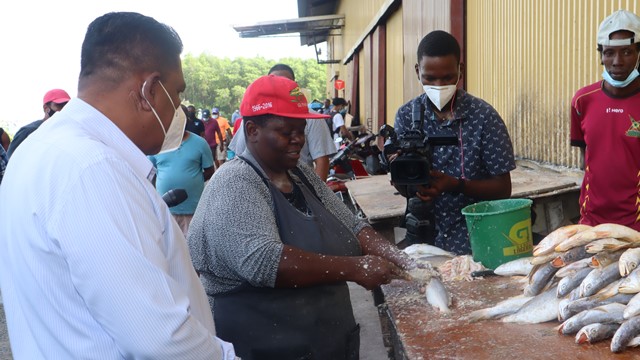 Minister of Agriculture, Zulfikar Mustapha engages a fish vendor at the Meadow Bank wharf