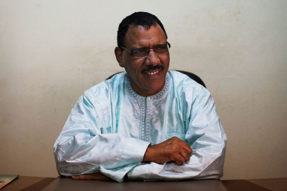 FILE PHOTO: Mohamed Bazoum sits at his pollitical party headquarters in Niamey, September 14, 2013. REUTERS/Joe Penney/File Photo