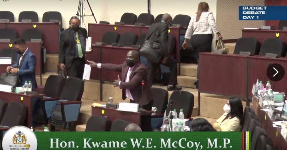 Minister within the Office of the Prime Minister, Kwame McCoy points to the Opposition as they walk out the House