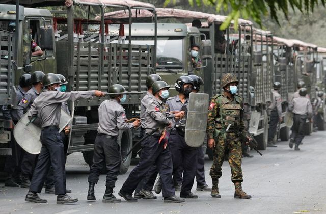 Police and soldiers are seen during a protests against the military coup, in Mandalay, Myanmar, February 20, 2021. REUTERS/Stringer