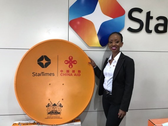Anne Maluki is showing the satellite television dish of StarTimes. (Xinhua/Duncan Sikoyo)