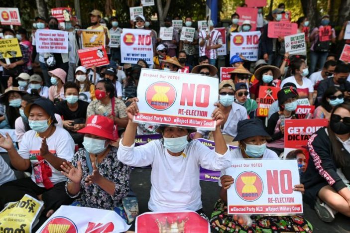 FILE PHOTO: Demonstrators hold placards during a rally against the military coup in front of Indonesian embassy in Yangon, Myanmar, February 24, 2021. REUTERS/Stringer