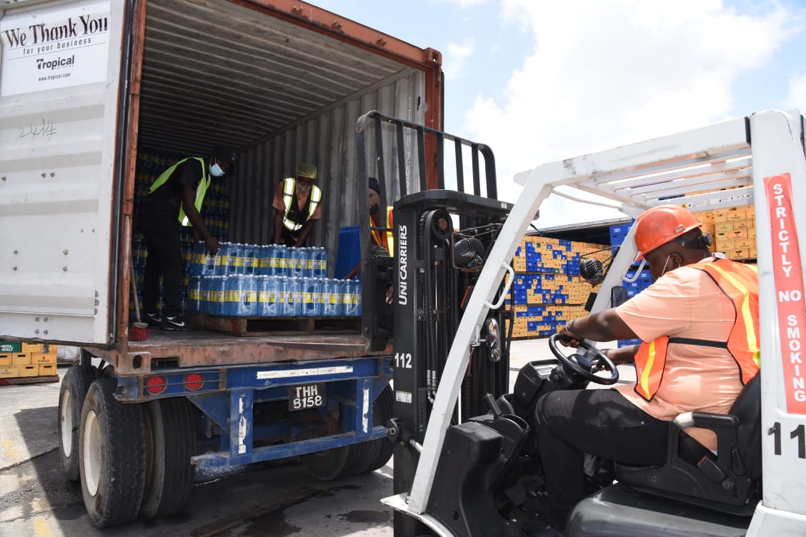 Banks DIH employee loading bottles of water into a truck for shipment to St. Vincent and the Grenadines 
