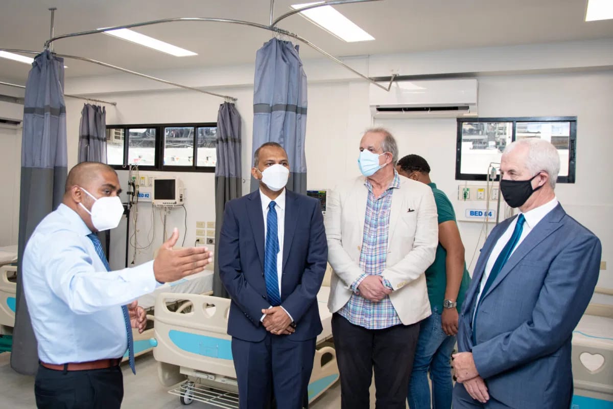 Minister of Health,  Dr. Frank Anthony, PAHO/WHO Guyana representative, Dr. Luis Felipe Codina, and Deputy British High Commissioner, Mr. Ray Davidson pay keen attention to eh Region four Health Officer during a tour of the facility
