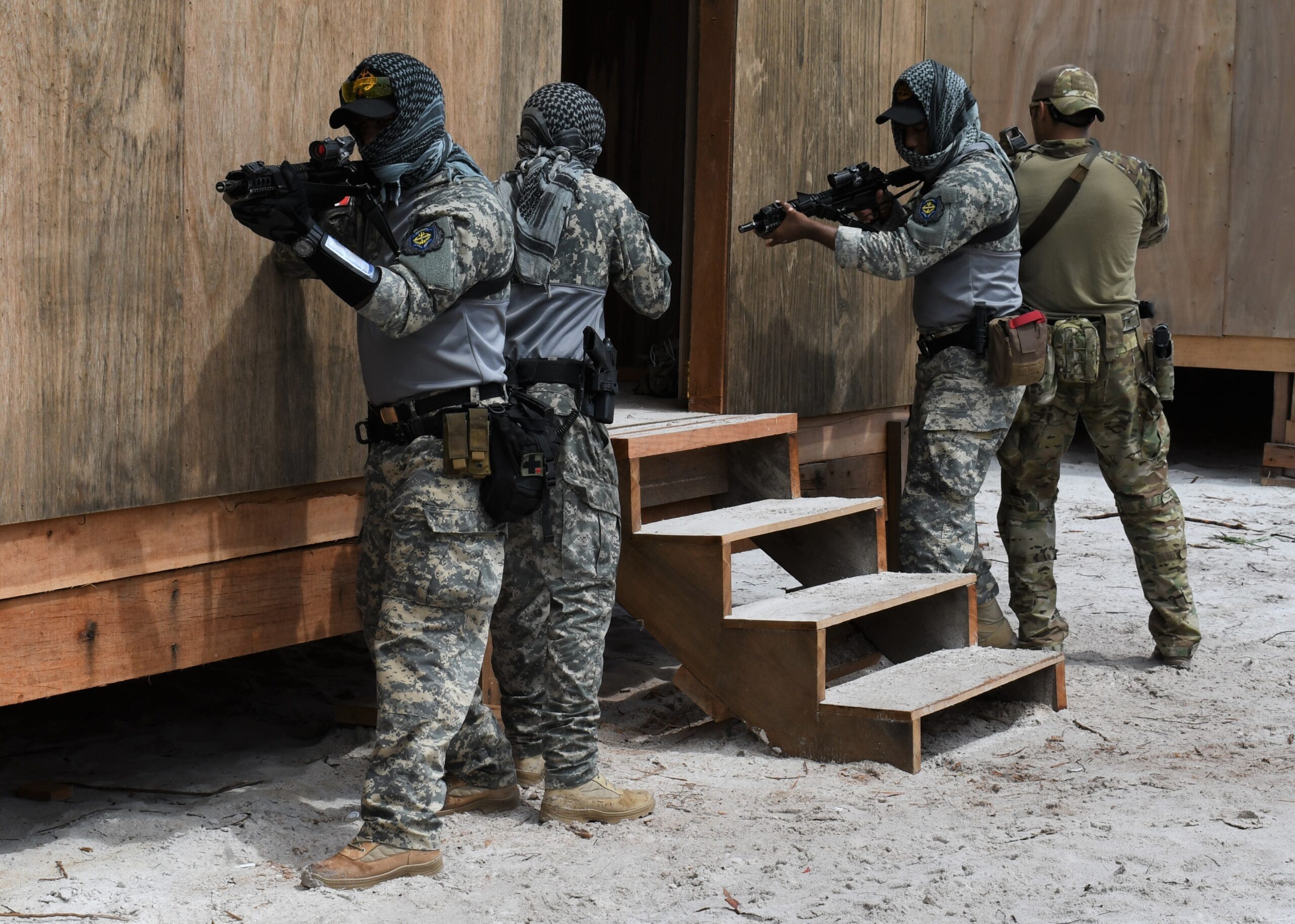 Members of the Dominican Republic Special Operations Force train with a member of the 54th Security Force Assistance Brigade, Florida National Guard, as part of an exercise in close quarters battle during Tradewinds, June 16, 2021 at Timehri. (U.S. Navy photo by Lt. Elizabeth Allen/Released)