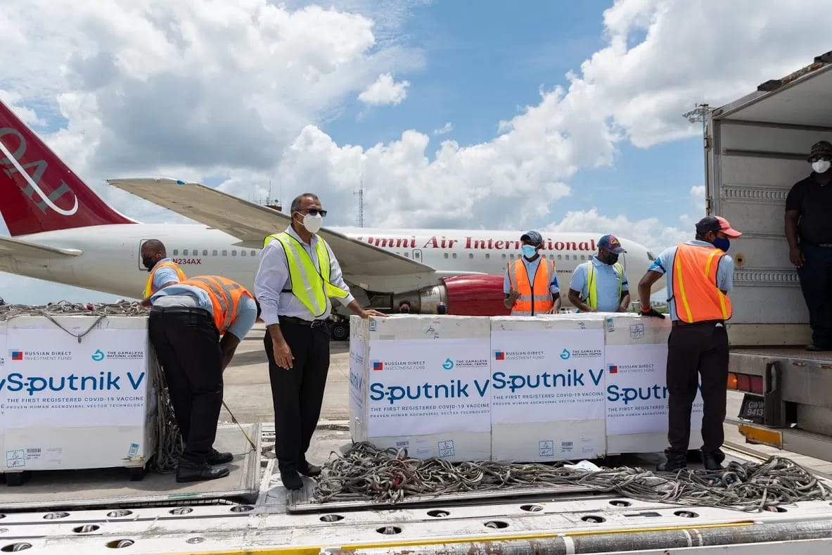 Minister of Health, Dr Frank Anthony stand beside the first batch of the Sputnik V vaccine that arrived in Guyana back in April this year