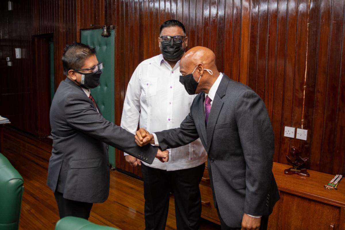 President of the Caribbean Development Bank, Dr Hyginus ‘Gene’ Leon greets Finance Minister, Dr Ashni Singh in the presence of President Irfaan Ali