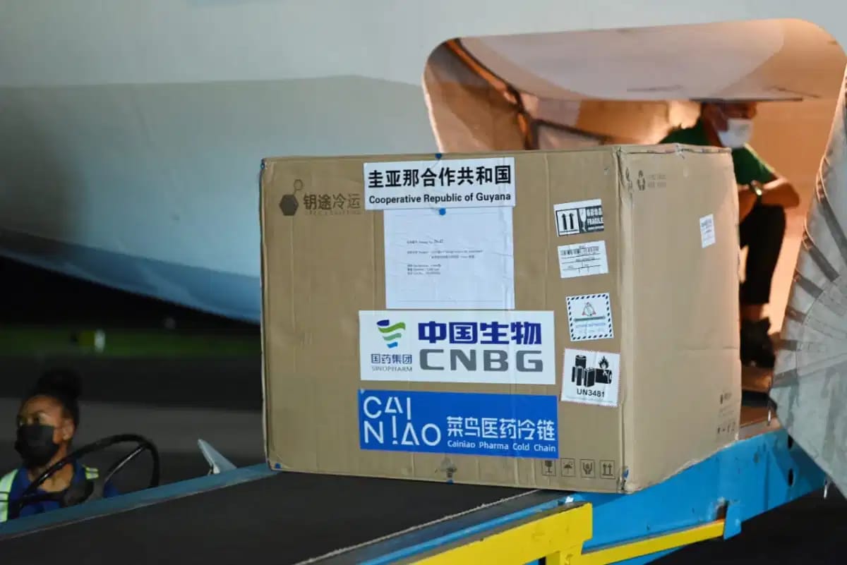 Batch of the Sinopharm vaccine being transported off the plane at the Cheddi Jagan International Airport