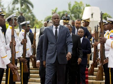 In this April 7, 2018, file photo, Haiti's President Jovenel Moise (centre) leaves the museum during a ceremony marking the 215th anniversary of revolutionary hero Toussaint Louverture's death at the National Pantheon museum in Port-au-Prince, Haiti. Moïse was assassinated after a group of unidentified people attacked his private residence, the country’s interim prime minister said in a statement Wednesday, July 7, 2021. (AP Photo/Dieu Nalio Chery, File)