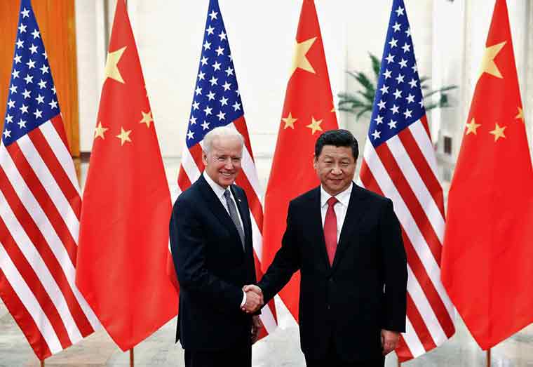 Chinese President Xi Jinping shakes hands with U.S. Vice President Joe Biden (L) inside the Great Hall of the People in Beijing December 4, 2013. REUTERS/Lintao Zhang/Pool//File Photo