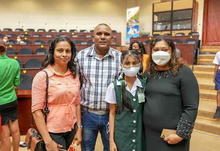 Top student Nirvana Wimal and her parents along with Minister of Education, Priya Manickchand (first right)