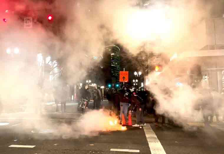 A riot was declared in Portland, Oregon, as demonstrators smashed windows and threatened to burn down the Justice Center